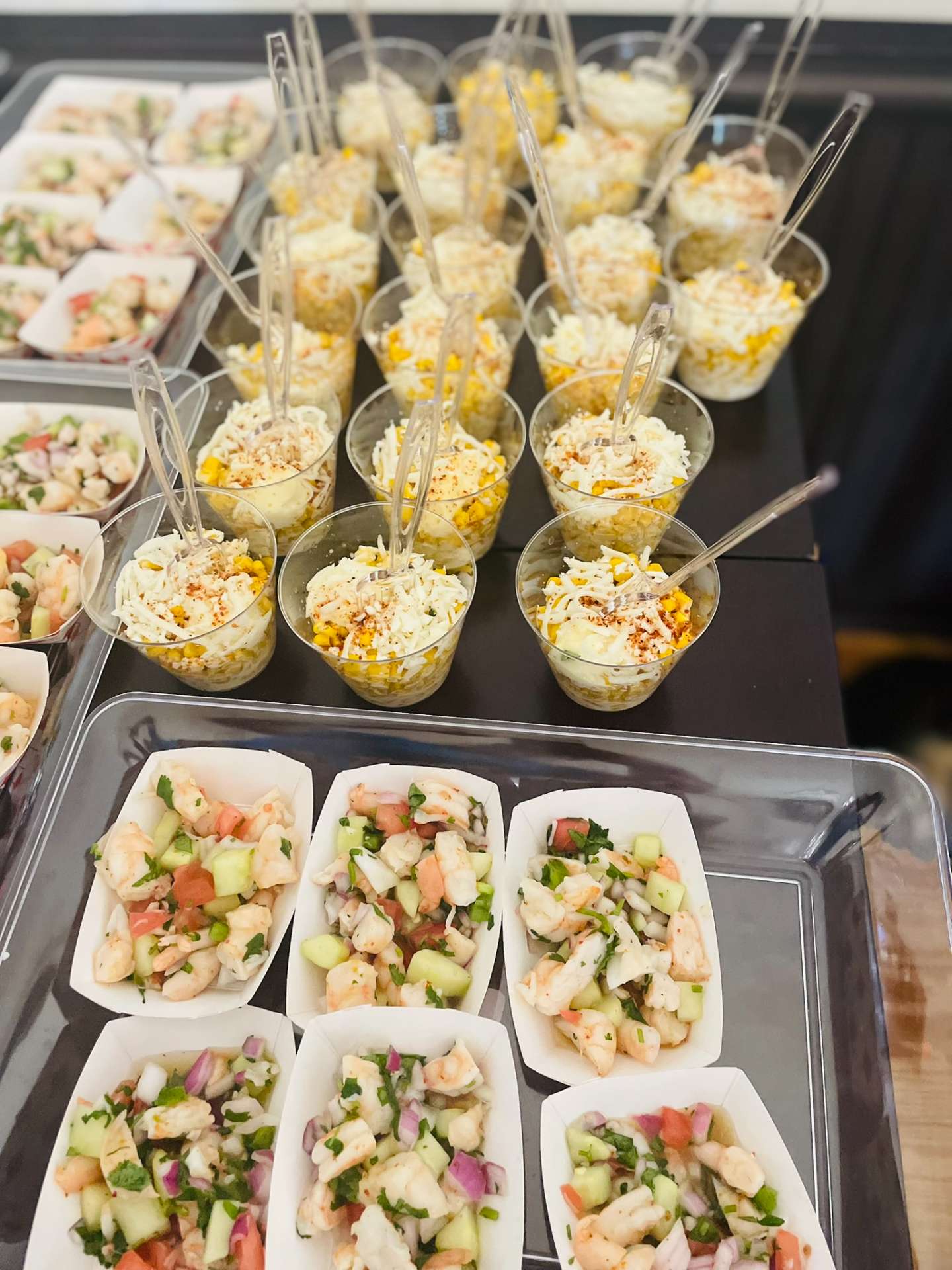 Individual shrimp ceviche boats and Mexican street corn elote cups for Stillwater catering events at Cafe Mona.