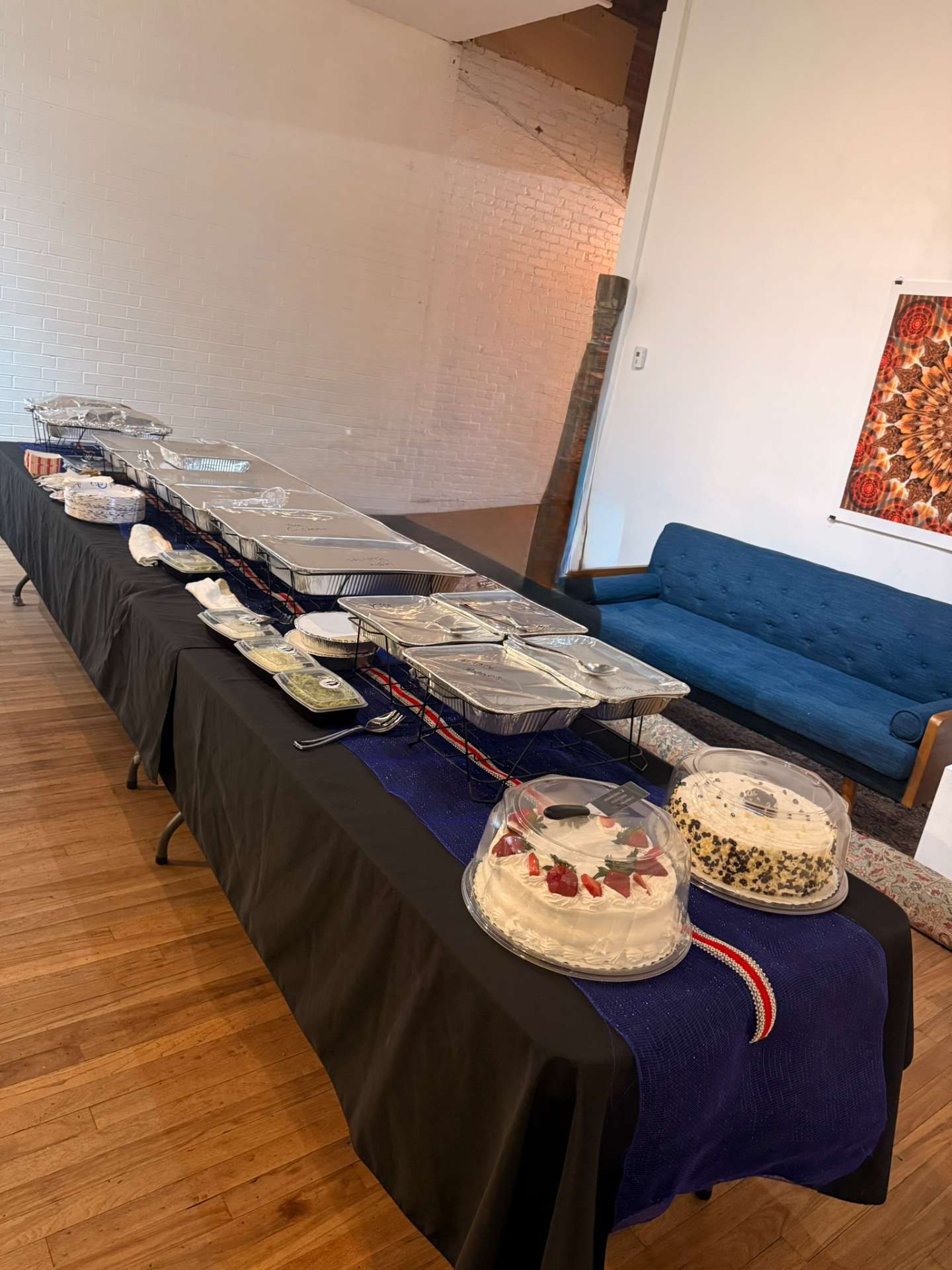 Corporate catering buffet setup with hot entrées and desserts catered by Cafe Mona in Stillwater, Oklahoma.
