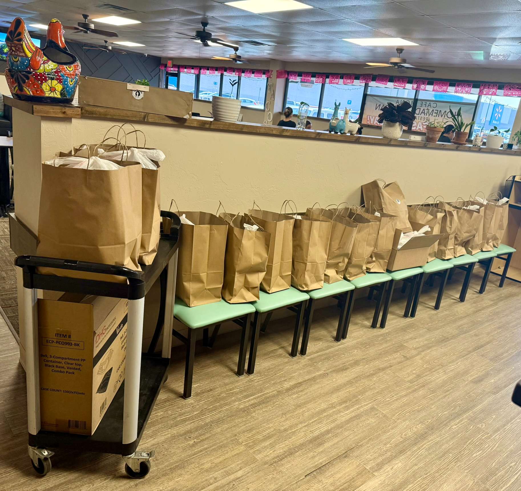 Large Cafe Mona catering order with dozens of takeout bags ready for pickup at the Stillwater Mexican restaurant.